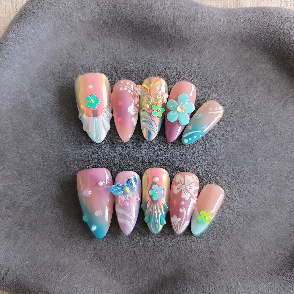 Handmade 3D nail art sculpture of embossed flowers and butterflies on an almond-shaped base.