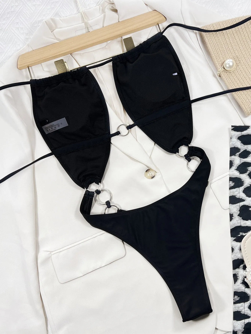 Steel Ring solid black sleeveless one-piece swimsuit for women on a white background.