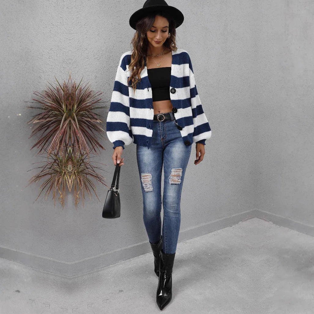 Blue striped women's cardigan sweater with button front and regular sleeves on a hanger.