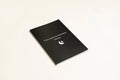 Black hardcover A5 dream journal notebook with lined pages showing business simplicity style