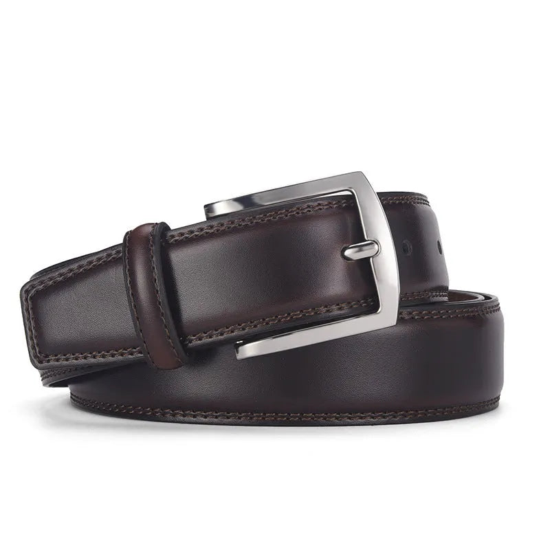 Men's classic black patent leather belt with a silver pin buckle on a flat surface.