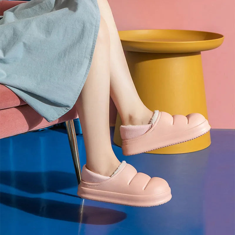 Waterproof EVA couple slippers in various colours showing hollow design and flat non-slip sole.