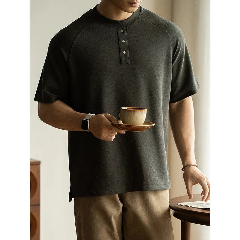 Casual loose-fitting grey pullover top with raglan sleeves and a textured terry fabric.