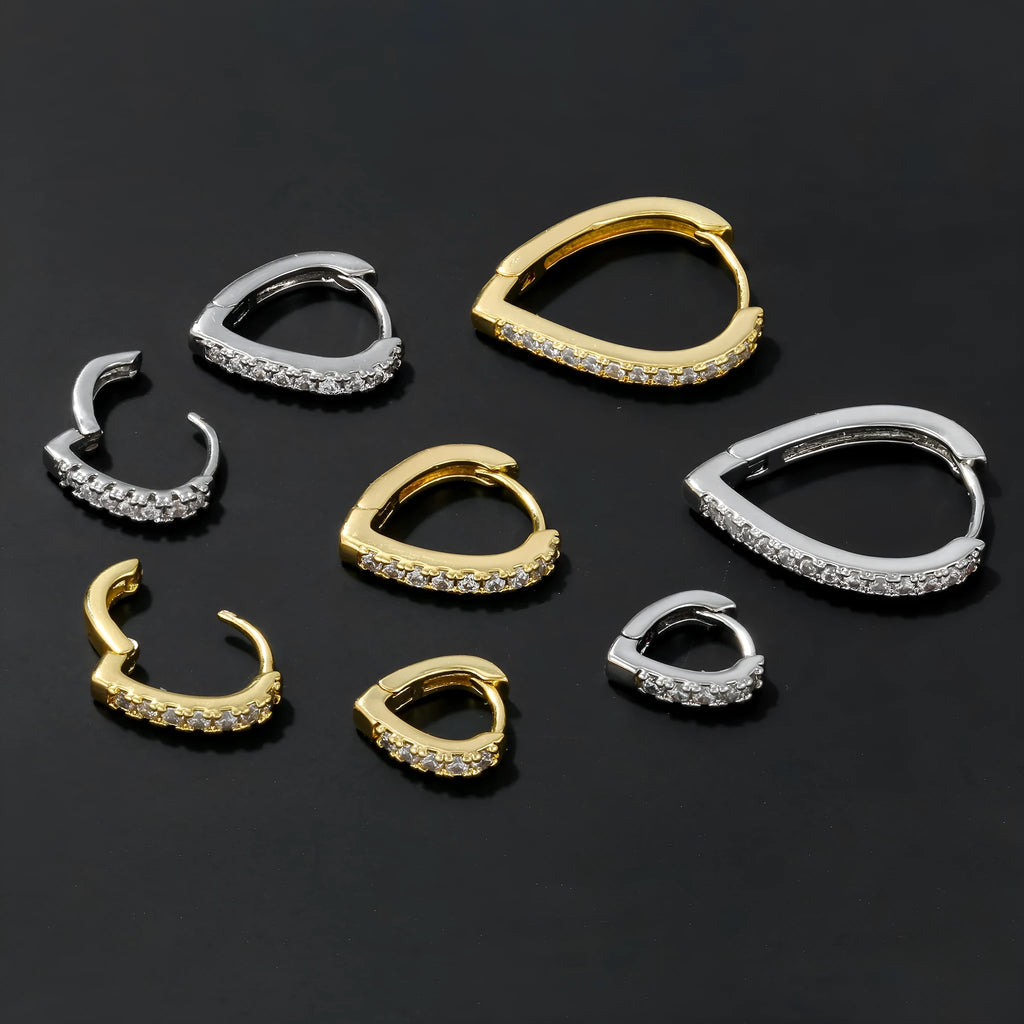 A geometric heart-shaped copper ear clip with a gold or white electroplated finish.