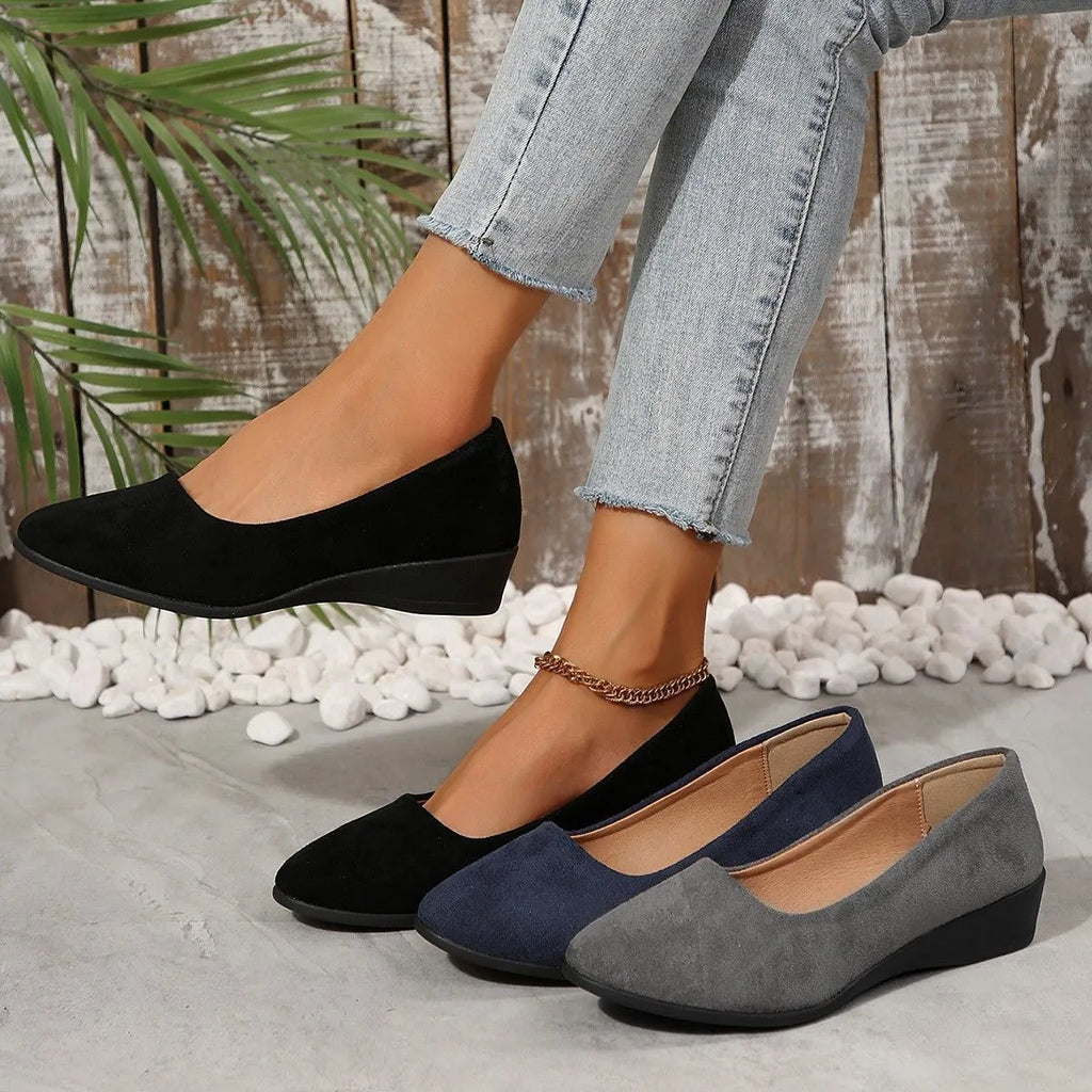 Women's plus size suede wedge pumps in light brown with a low rubber heel and round toe.