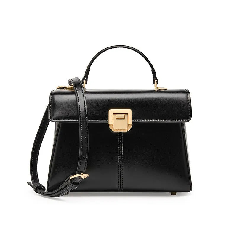 Black genuine leather women's shoulder bag with clasp closure showing square shape and adjustable strap