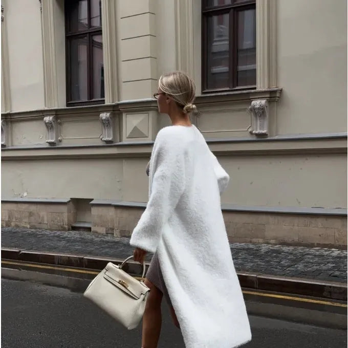 White knitted cardigan jacket with long sleeves and loose fit, shown as a versatile women's outerwear garment