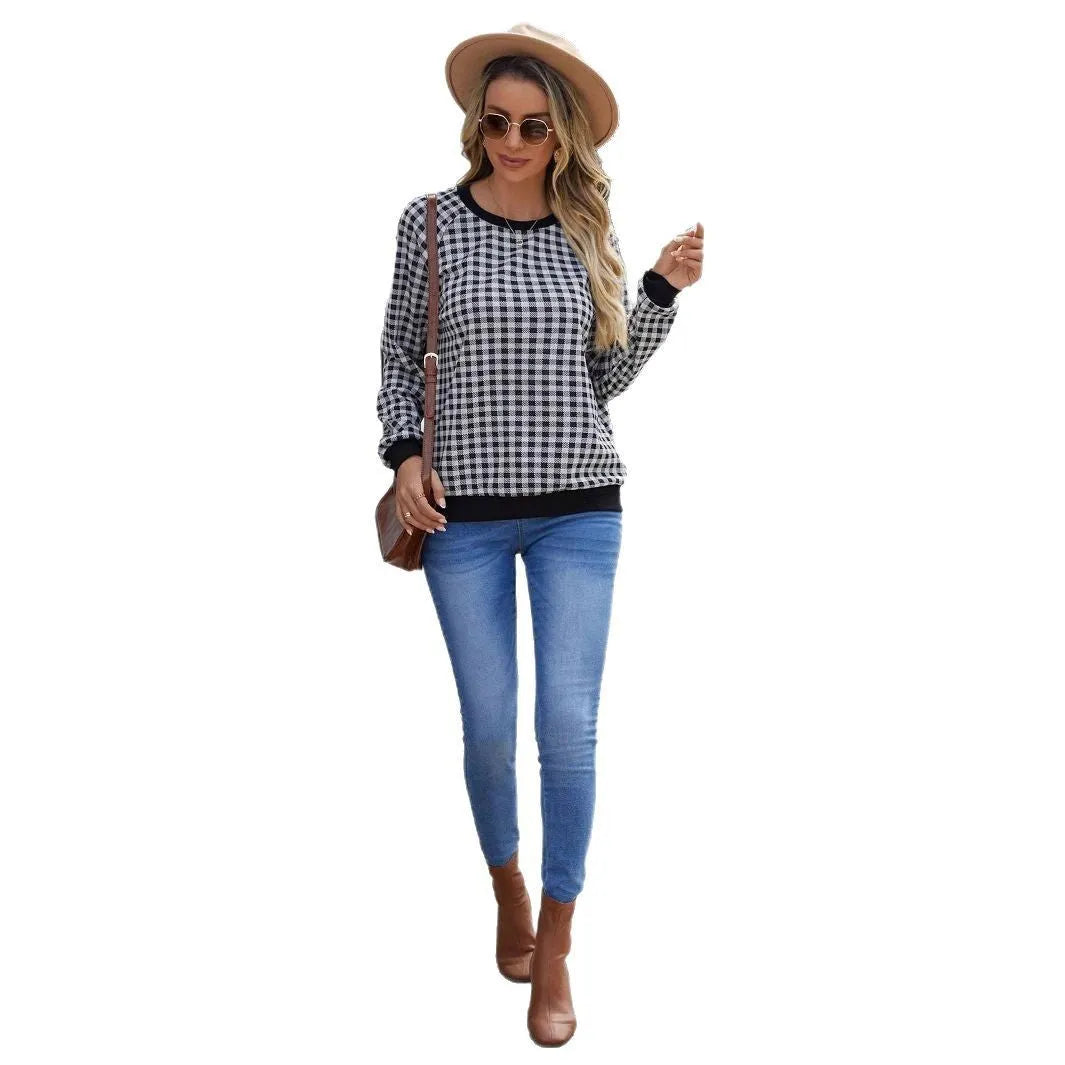 Black Japanese plaid pattern long sleeve pullover sweater on a hanger.