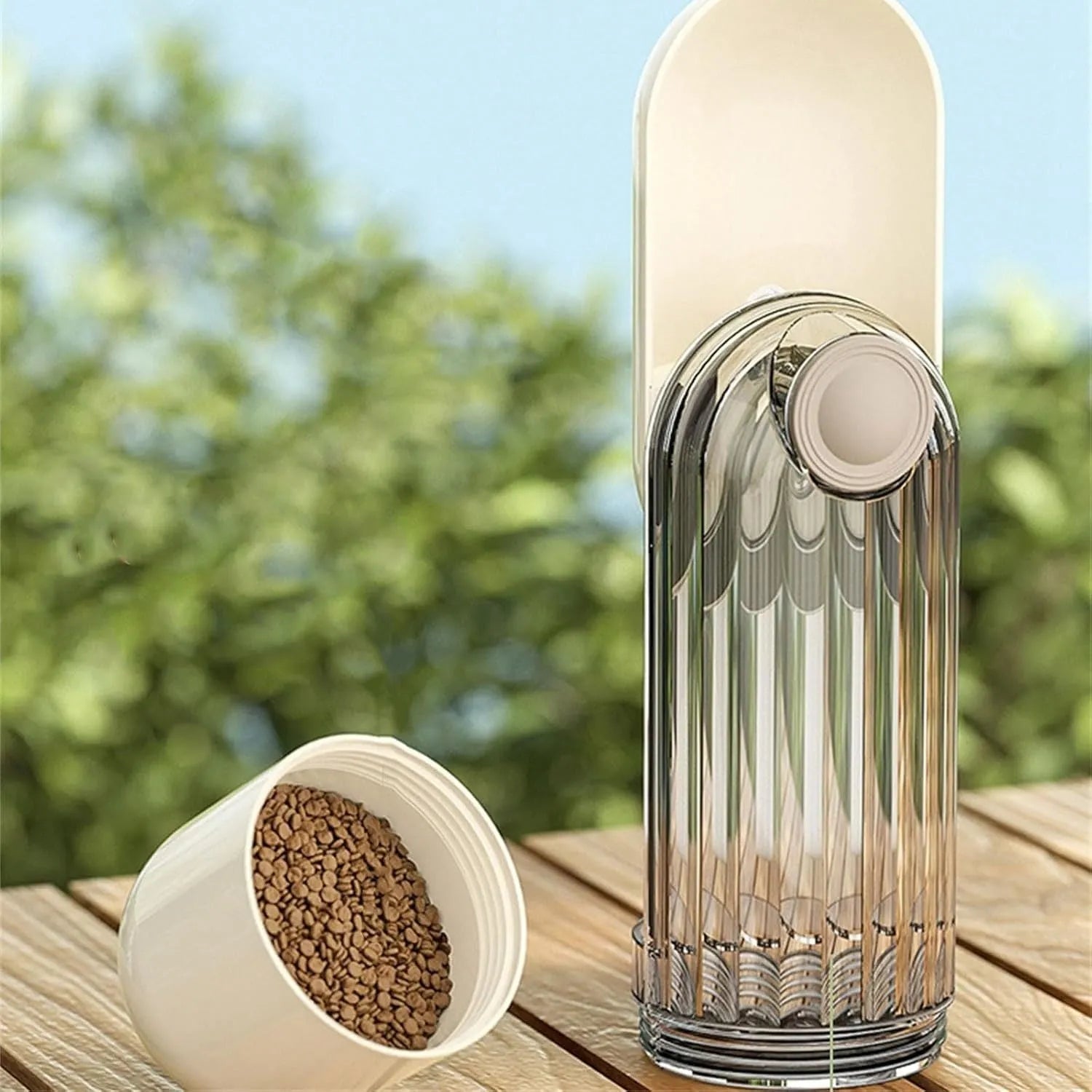Beige and green foldable dog water bottle with food dispenser shown collapsed and open.