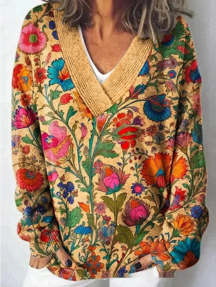 Women's V-neck sweatshirt with a white background and a textured 3D floral printed pattern.