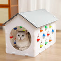 Plastic cat scratch board integrated with tunnel and nest containing bell ball