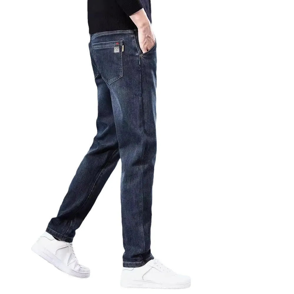 Man wearing slim straight blue-grey casual trousers with a micro-elastic fit and zipper fly.