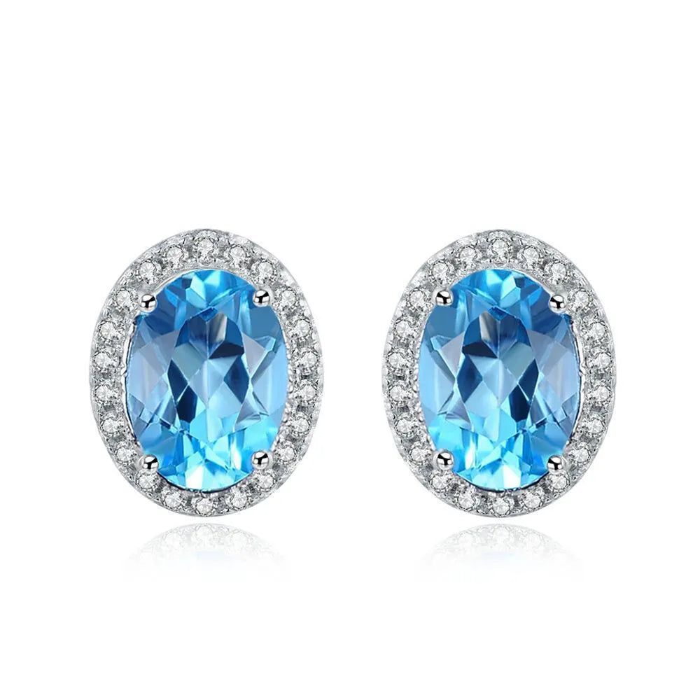 925 sterling silver geometric jewellery set with Blue Topaz gems showing necklace, earrings, ring, and pendant