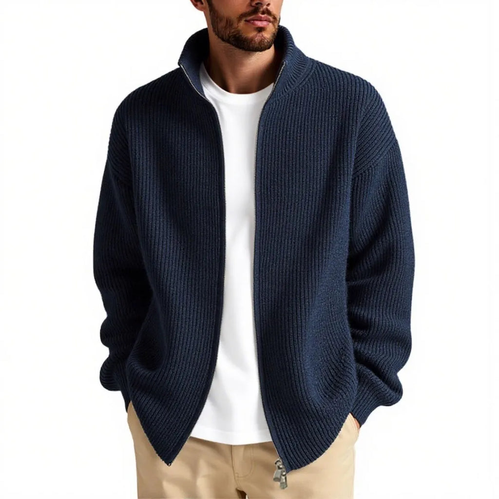 Man wearing a loose grey cardigan sweater with button-up front and V-neck.