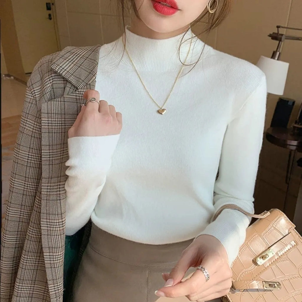 Women's slim fit knitted long sleeve top in viscose fabric, shown in apricot colour.