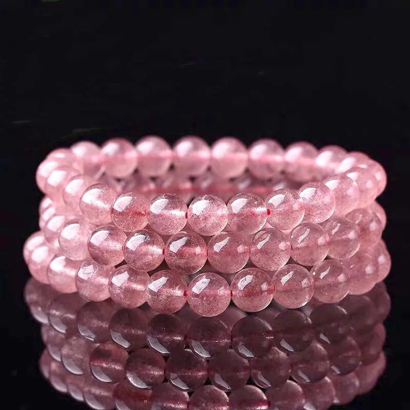 Natural strawberry quartz bracelet for women with polished beads in 6mm, 8mm, or 10mm size options.