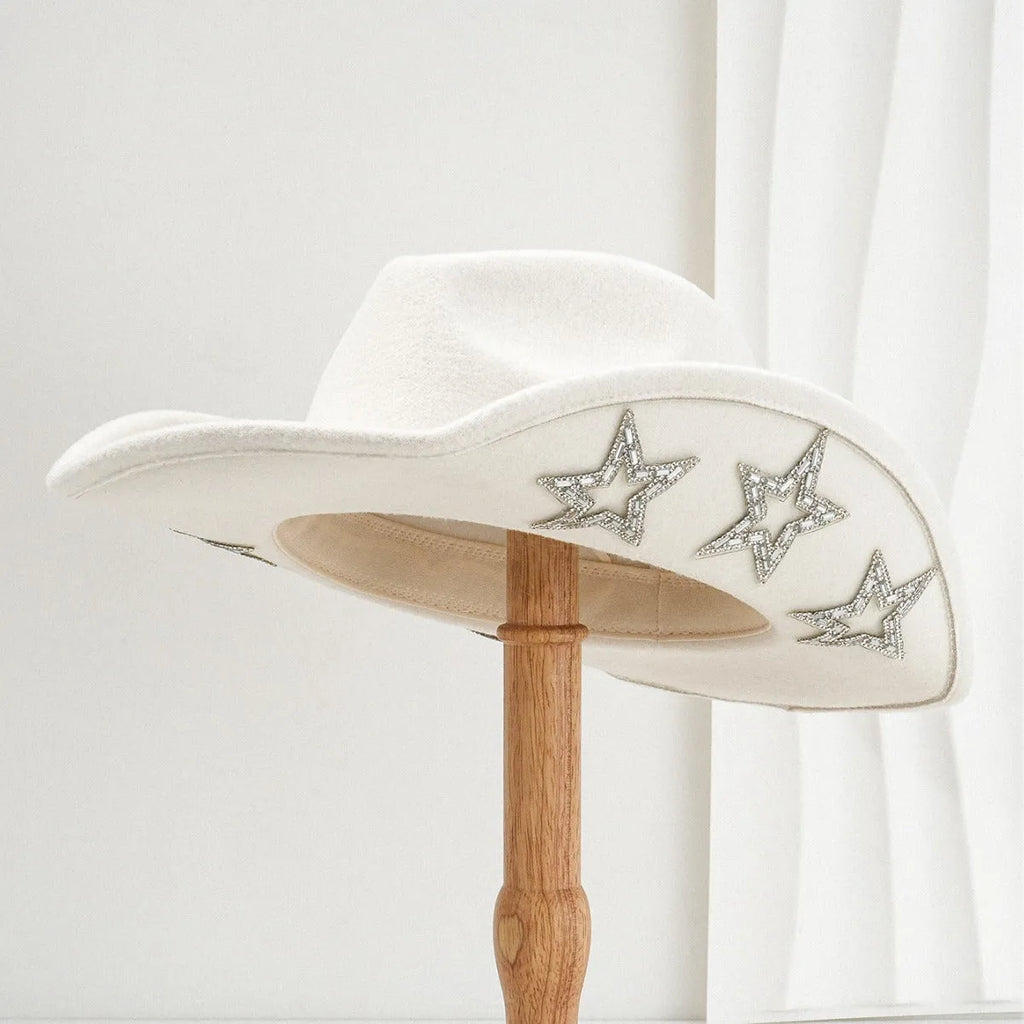 Beige polyester Western top hat with a conical crown and a silver hexagonal star decoration on the front.