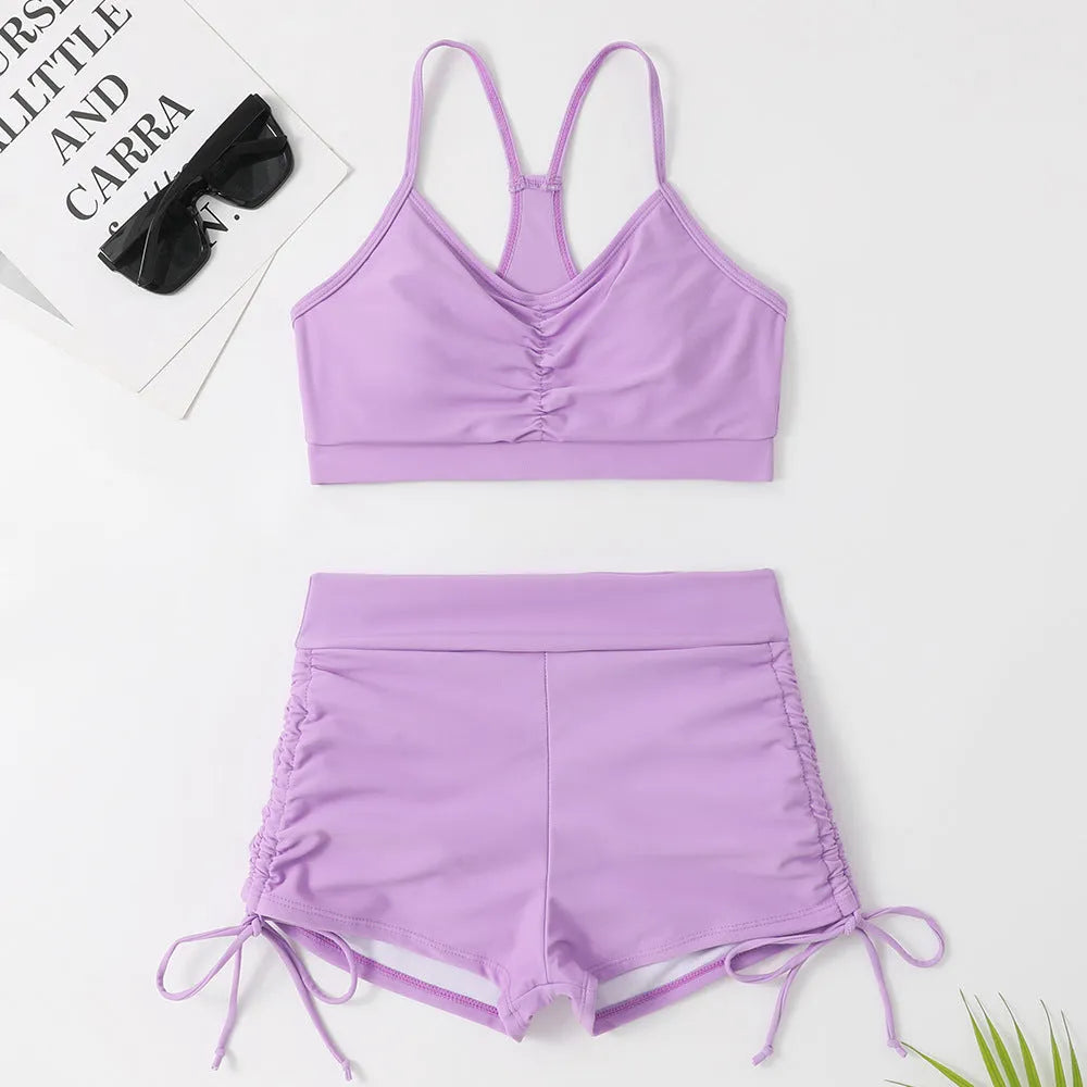 Women's high waist split bikini swimsuit in violet and black colours with sleeveless briefs style
