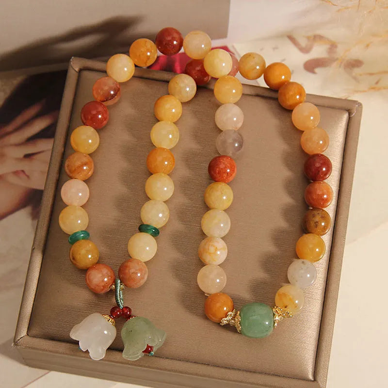 Natural green jade multi-layer wrap bracelet for women with a silver orchid pendant charm.