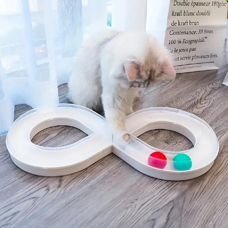 Blue and white plastic cat turntable track ball toy with a teasing stick on a flat surface.