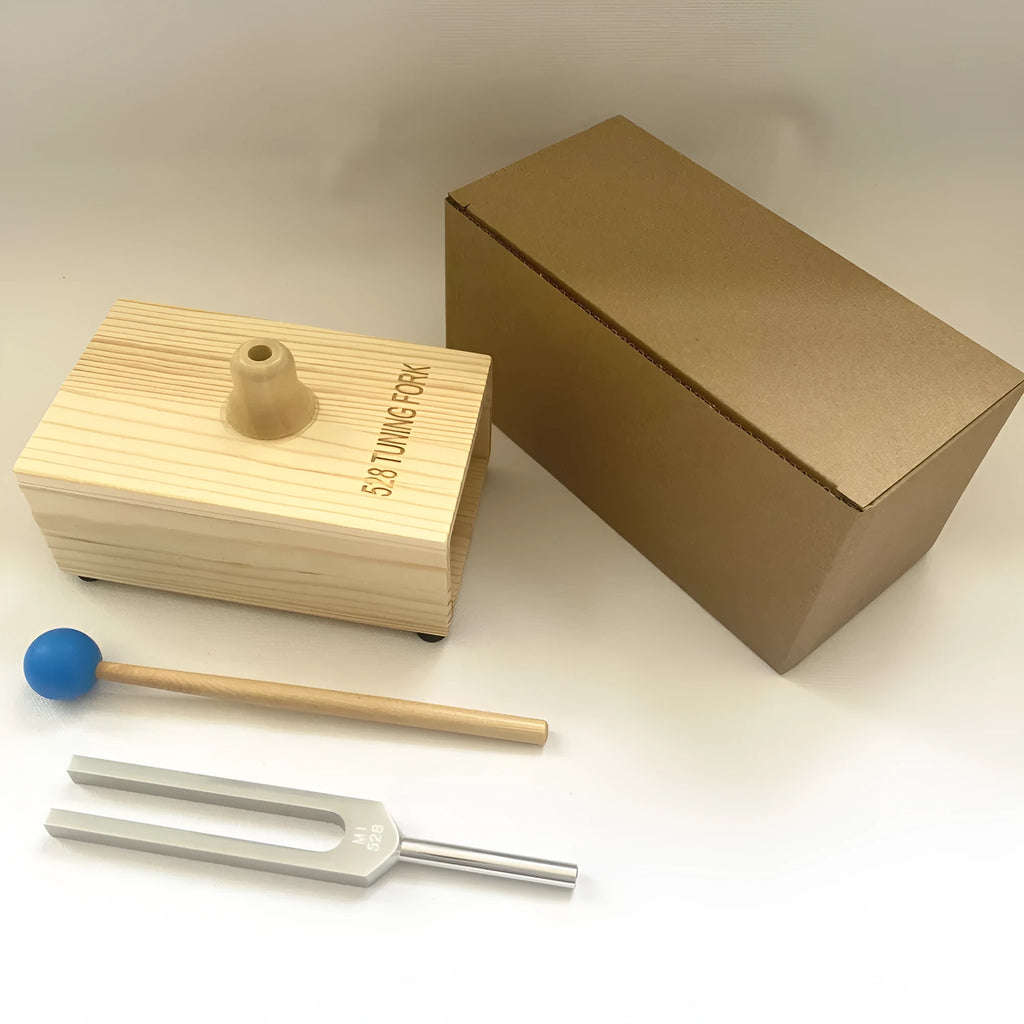 432Hz aluminium tuning fork and small speaker set on kraft paper packaging