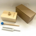 432Hz aluminium tuning fork and small speaker set on kraft paper packaging