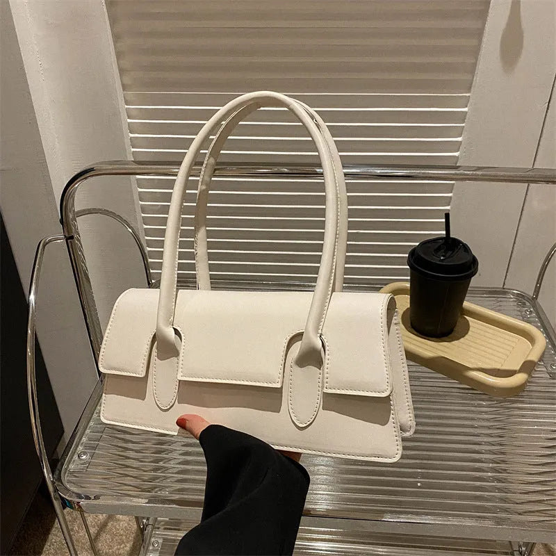 Women's small square bag in horizontal shape with single shoulder strap and document organisation interior