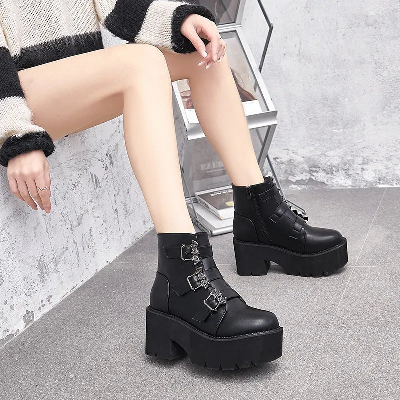 Black women's punk ankle boots with bat buckle, side zipper, thick heel, and round toe.