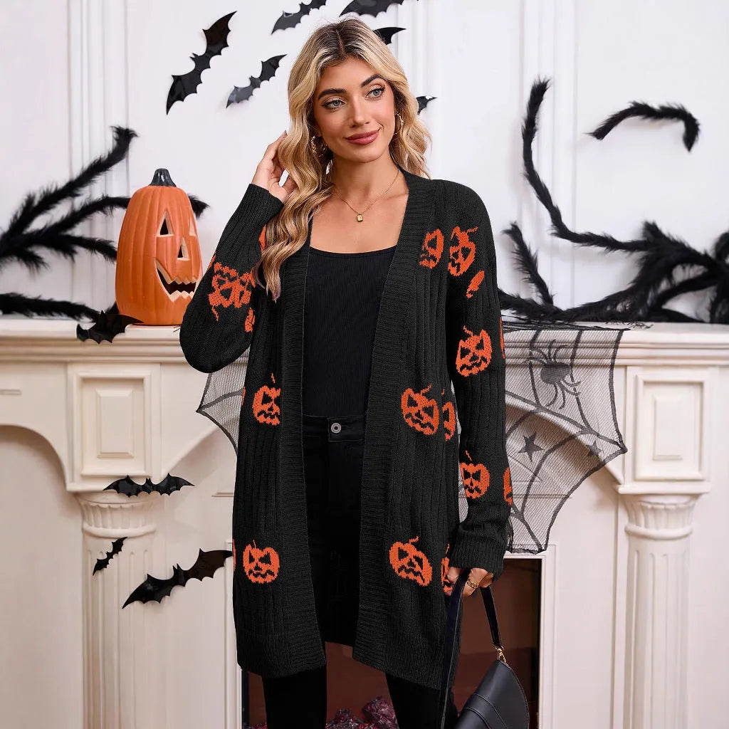 Women's black Halloween cardigan with orange pumpkin head jacquard pattern, shown as a straight-cut medium-length knit.