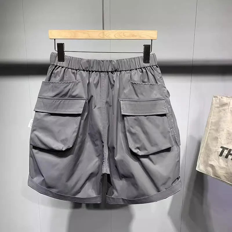 Men's loose fit black casual shorts with large side pockets and an elasticated waistband.