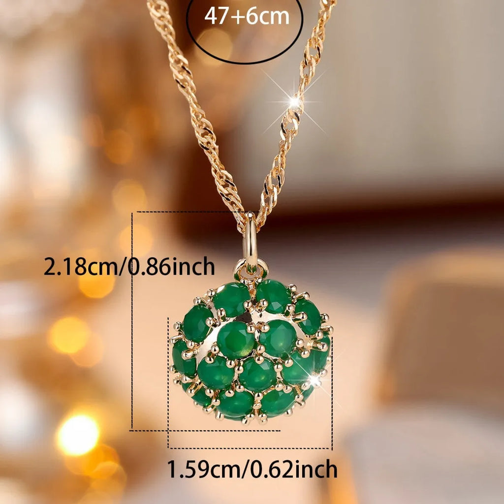 Round emerald and diamond pendant on an adjustable champagne gold electroplated copper chain necklace.