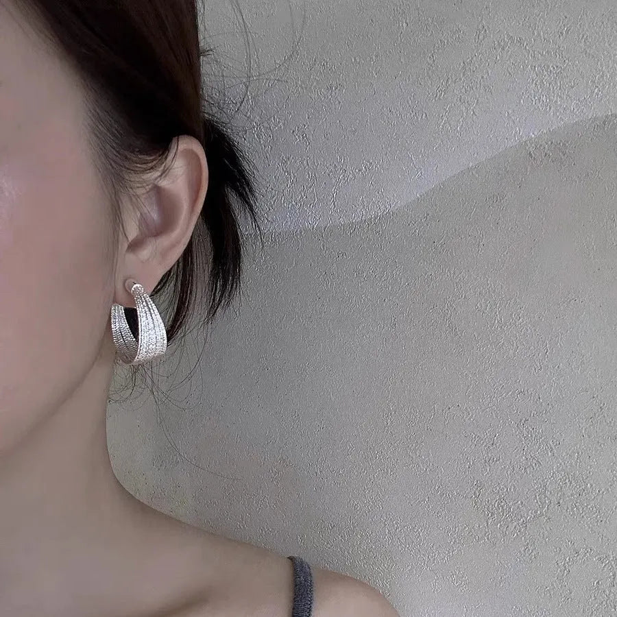 Geometric copper earrings with electroplated silver and gold finishes including stud and clip styles