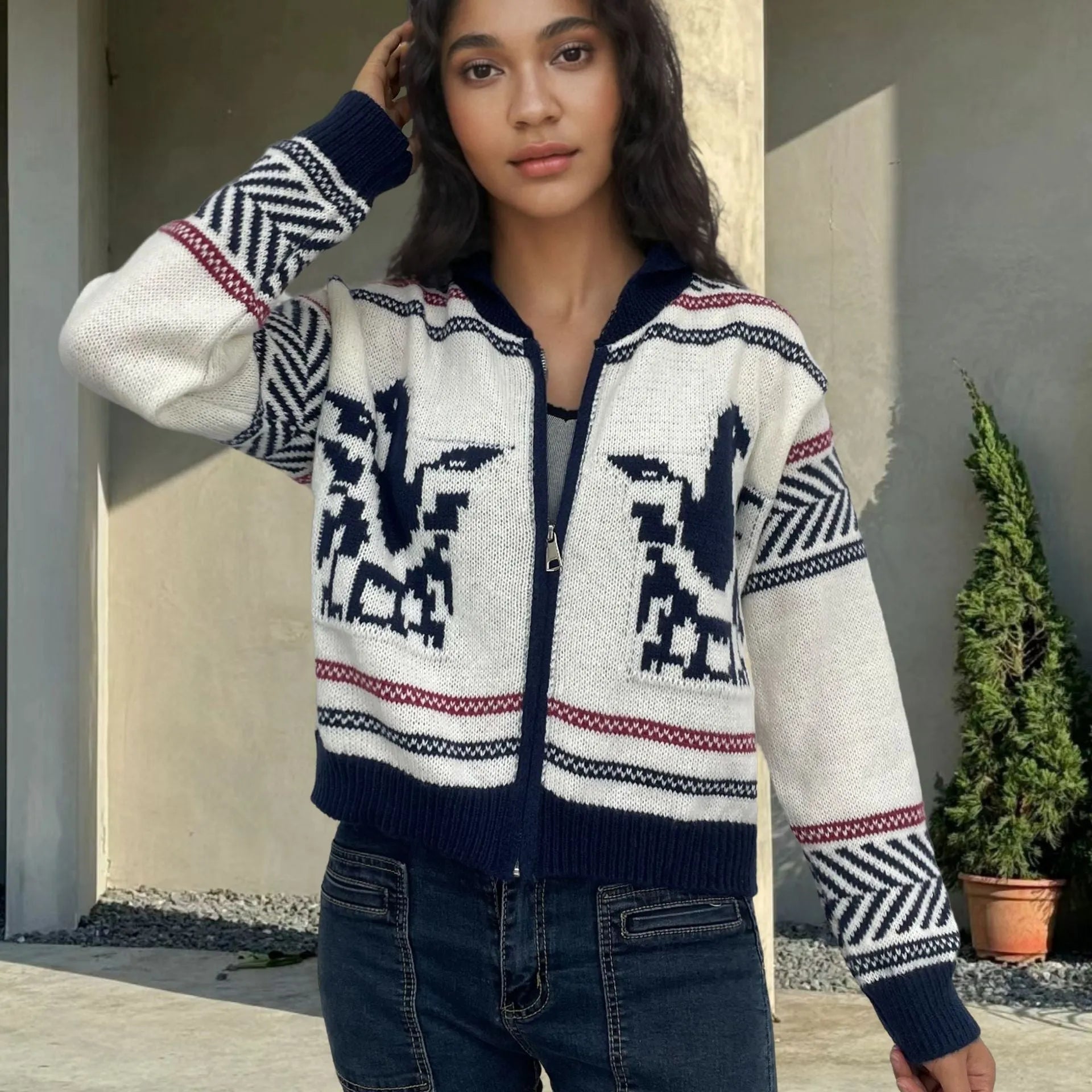 White women's zip-front cardigan sweater with contrast stripe pattern and lapel collar.