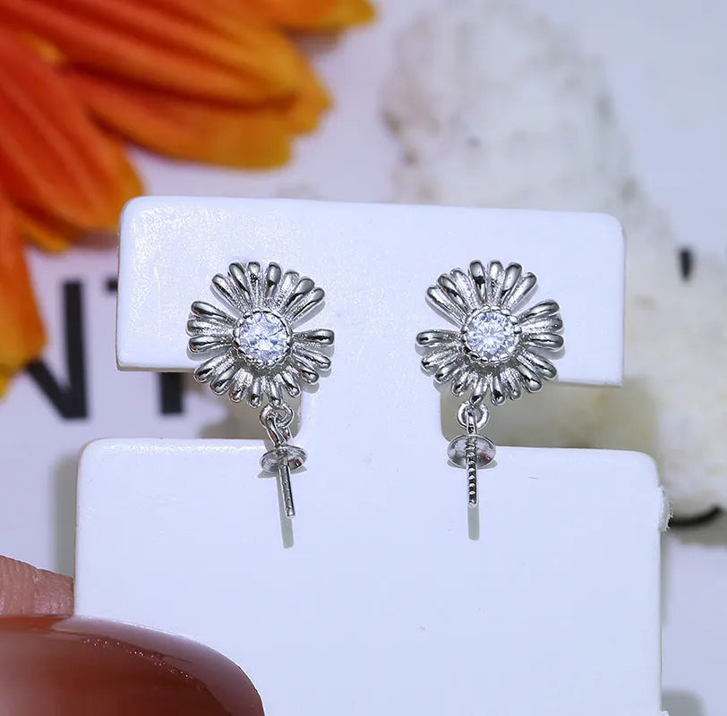 S925 sterling silver baroque flower design earrings and ring holder on a table.