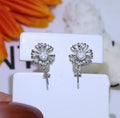 S925 sterling silver baroque flower design earrings and ring holder on a table.
