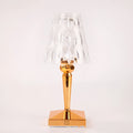 Rose gold portable touch control night light on a wooden surface.