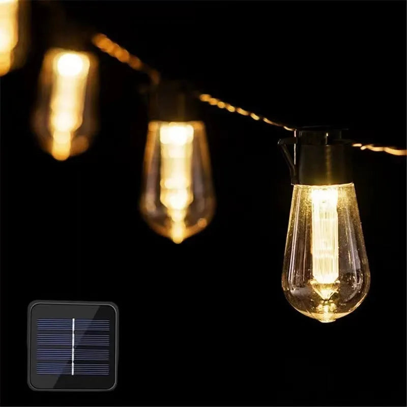 Retro infusion bottle shaped glass bulb outdoor string lights in garden setting