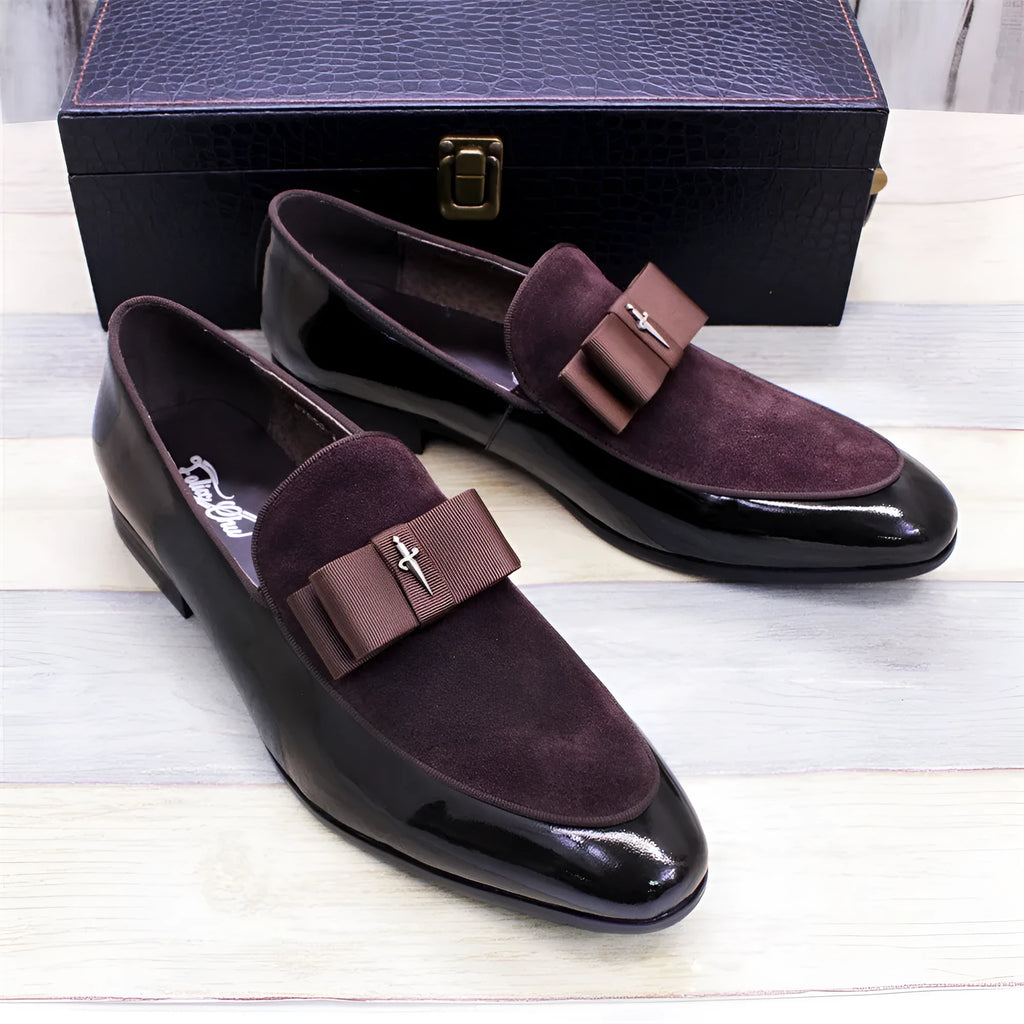 Men's glossy black patent leather low-top shoes with a tassel detail on a rubber sole.