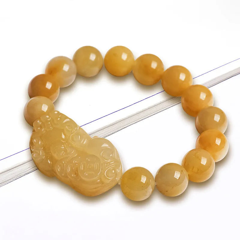 Hand-carved Golden Thread Jinsi Jade money bracelet showing carved detail, offered in large and small unisex sizes.