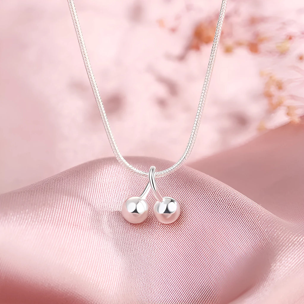 Silver cherry necklace for women with fruit pendant on a snake bone chain, adjustable length.