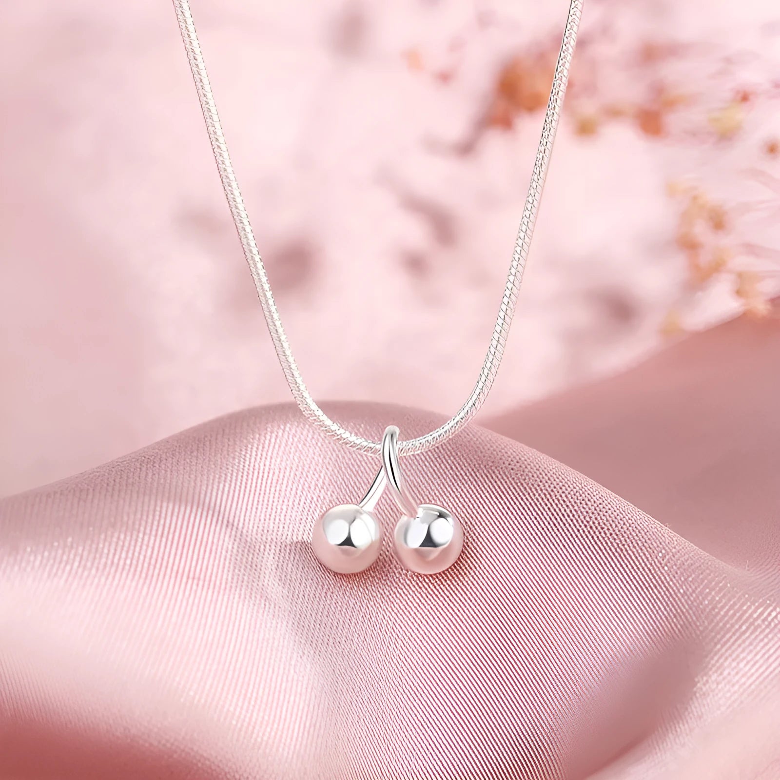 Silver cherry necklace for women with fruit pendant on a snake bone chain, adjustable length.