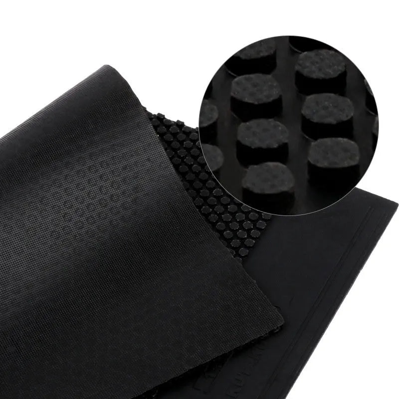 Single square sheet of black table tennis rubber with small pimpled particle texture.