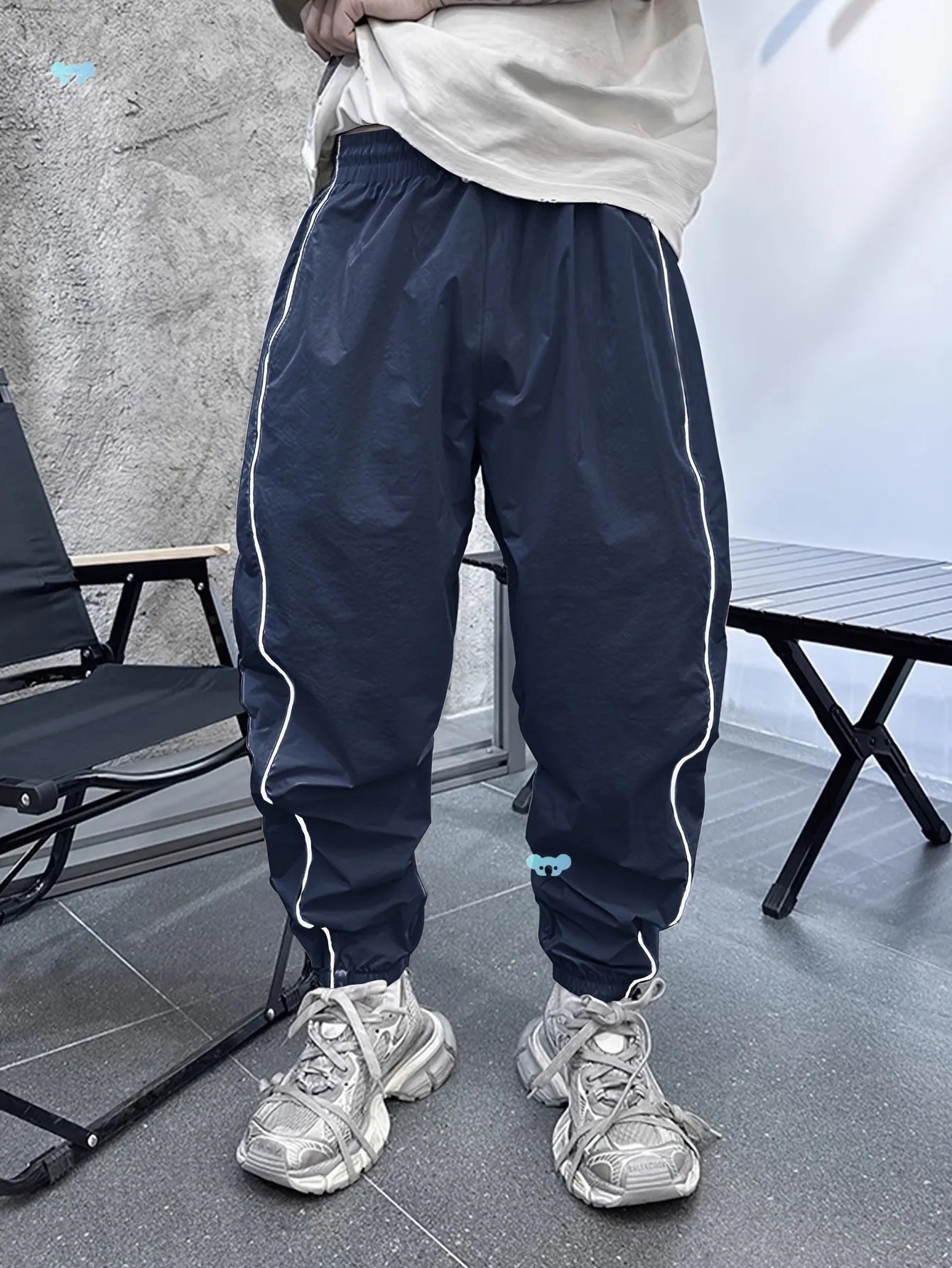 Man wearing blue loose-fit cropped sports trousers made from bamboo fibre.