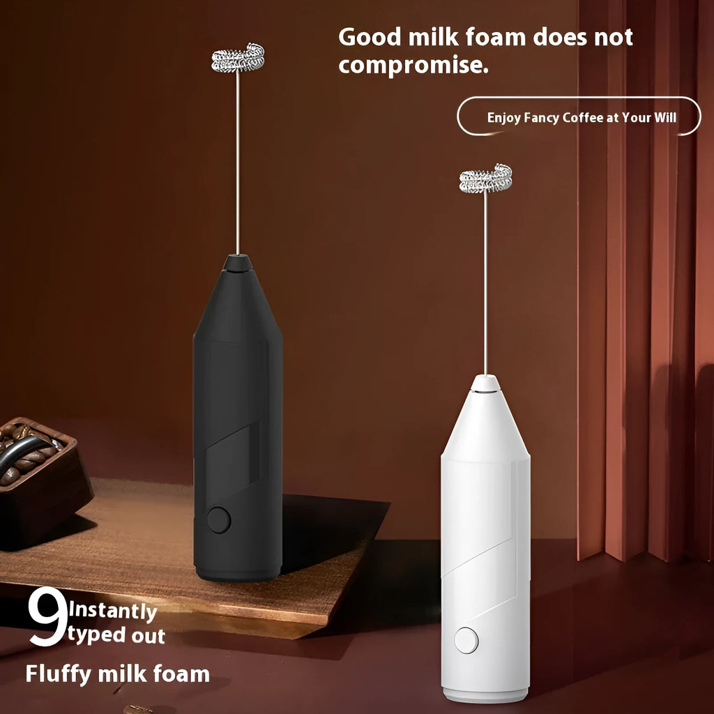 Mini handheld electric milk frother in black colour with stainless steel whisk and USB charging port.