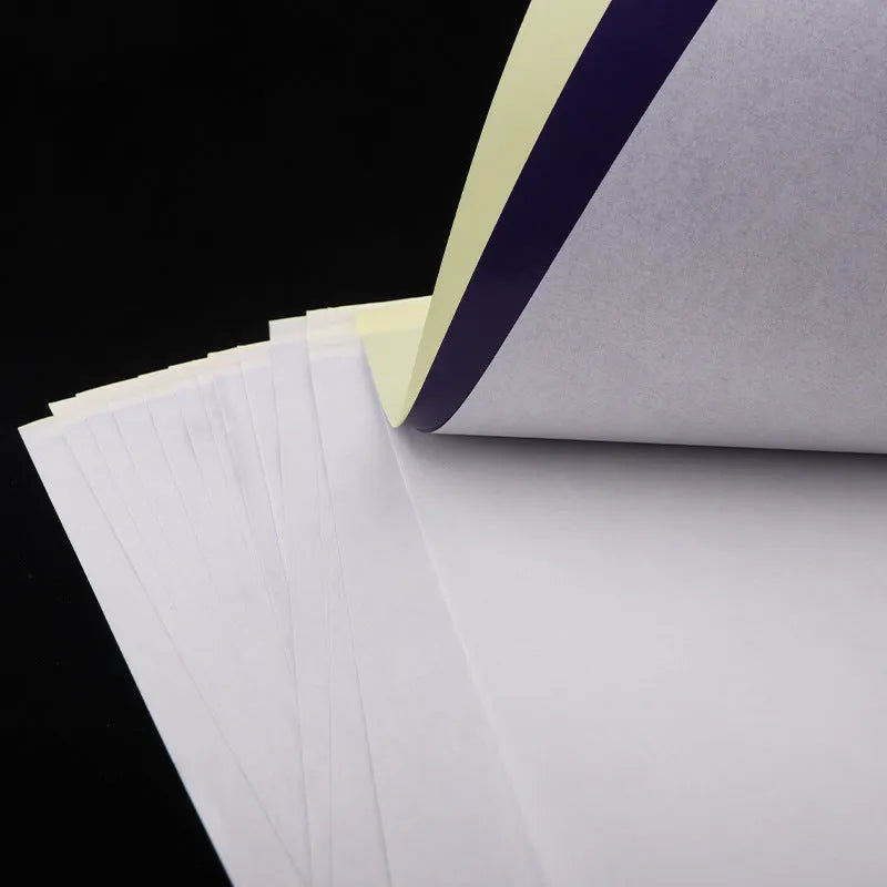 Stack of A4 tattoo transfer paper sheets with clear quadruple lines and transfer gel tube