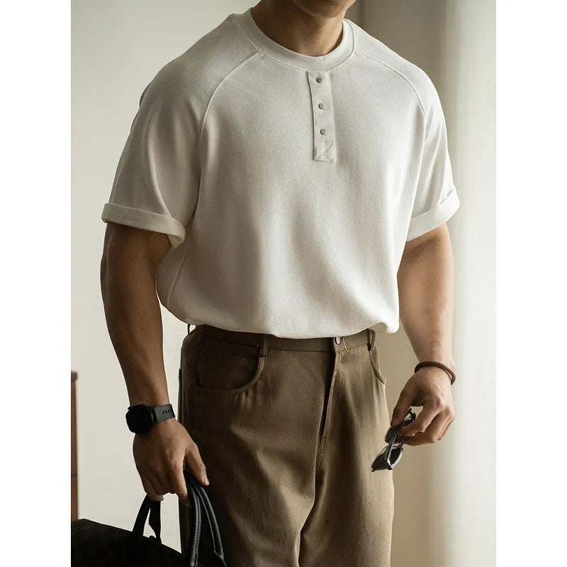 Casual loose-fitting grey pullover top with raglan sleeves and a textured terry fabric.