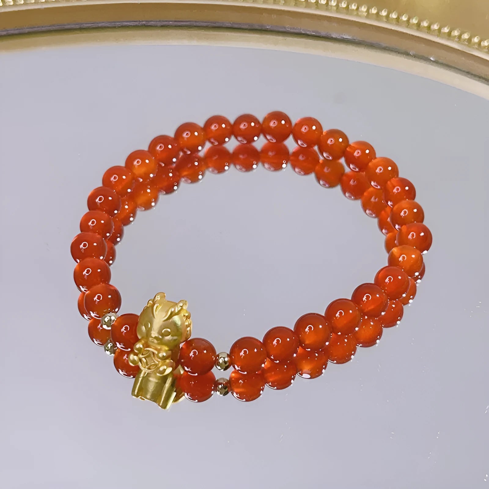 Handcrafted red agate bracelet for women with dragon charm, Chinese style design.