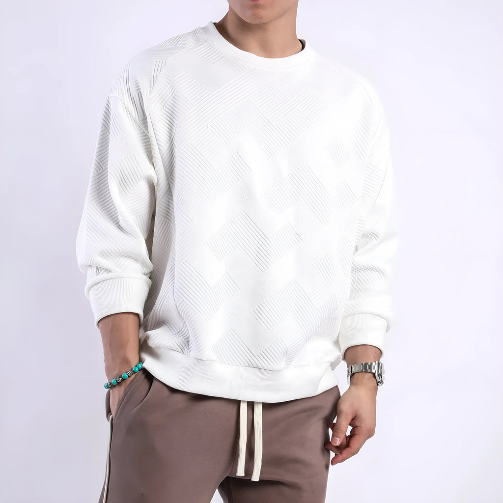 Man wearing a loose fit Army Green twill jacquard long sleeve pullover sweater.