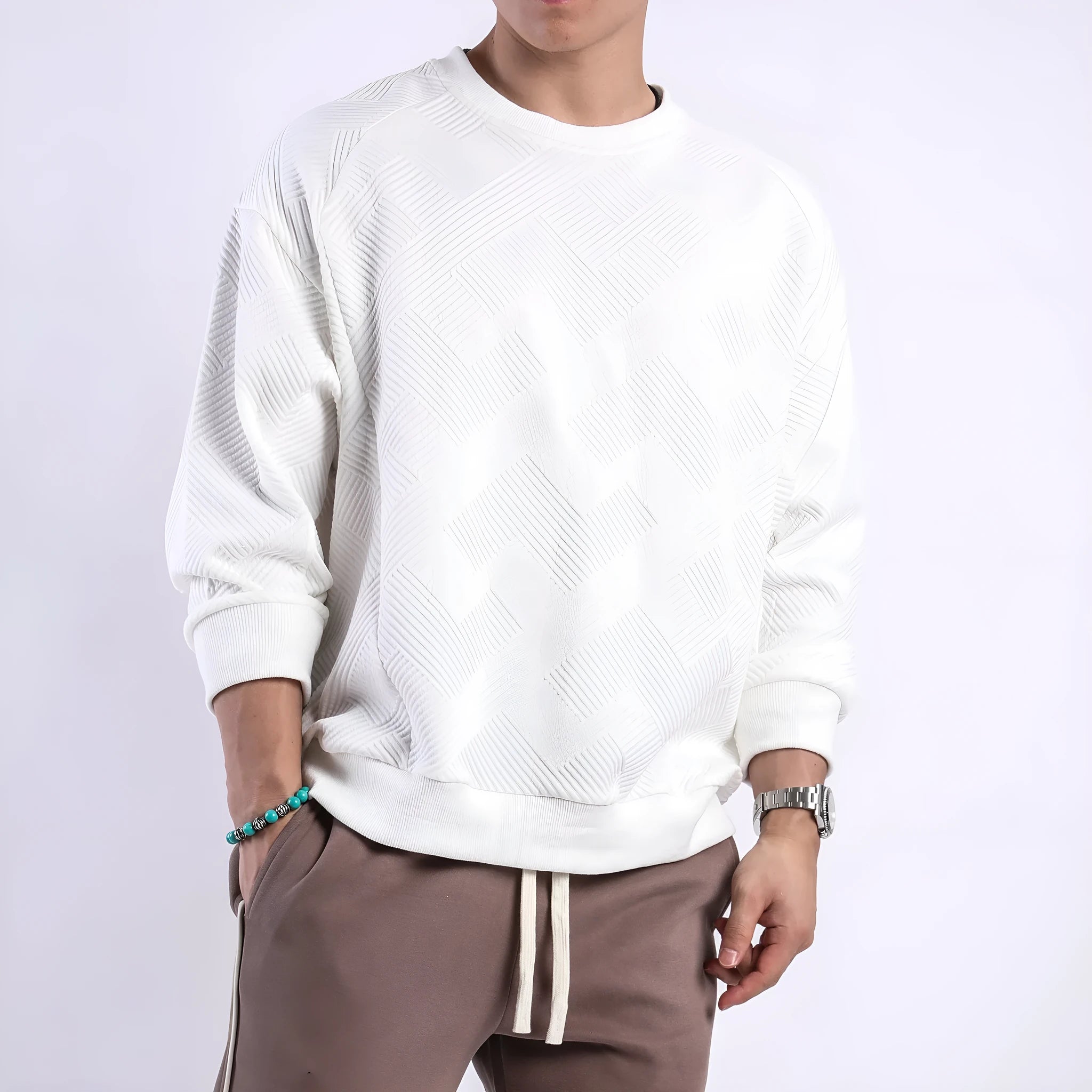 Man wearing a loose fit Army Green twill jacquard long sleeve pullover sweater.
