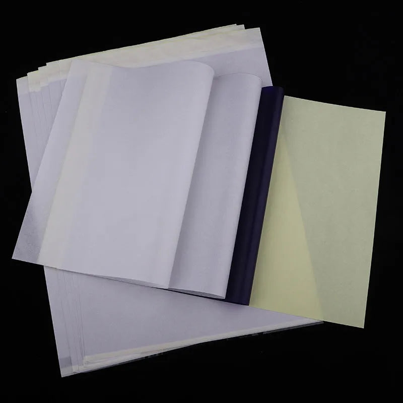 Stack of A4 tattoo transfer paper sheets with clear quadruple lines and transfer gel tube
